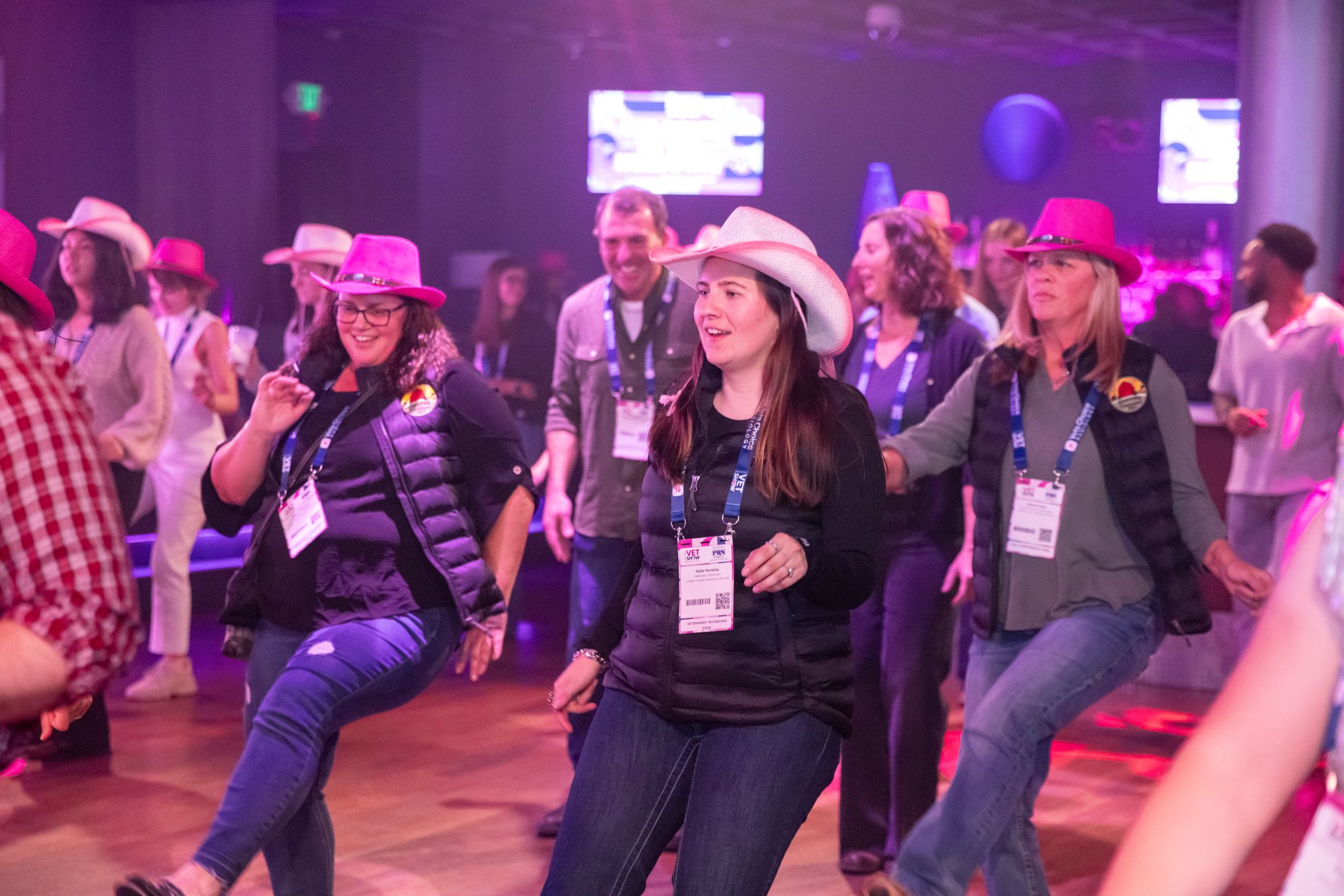 Largo group on dance floor wearing cowboy hats and dancing